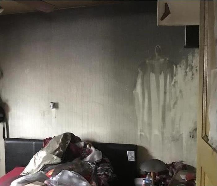 Living room walls are damaged by soot and smoke